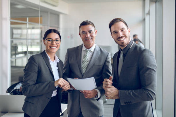 istock Portrait of  three mixed age business people at work 877144722