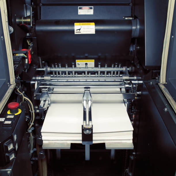 istock Fragment of digital offset machine with paper ready for printing 877148940