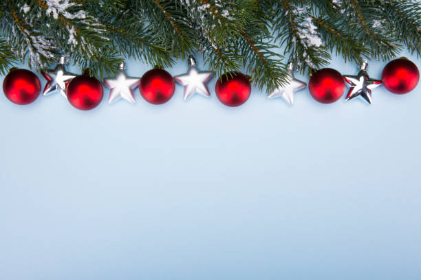 istock Christmas and New Year. Branches of a tree on a blue background. Copy-space. 877153462