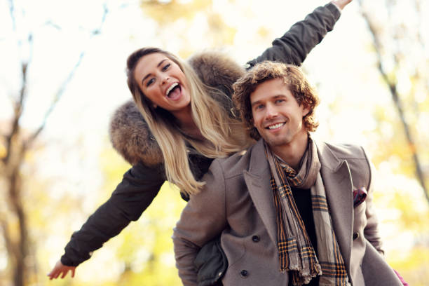 istock Happy couple walking in the forest during autumn 877153482