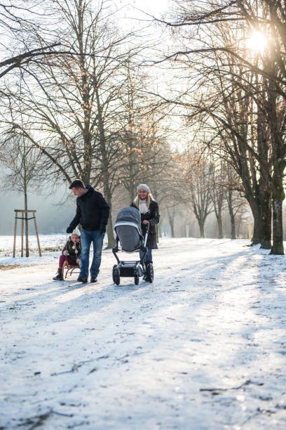 Family in winter Family in winter baby stroller winter stock pictures, royalty-free photos & images