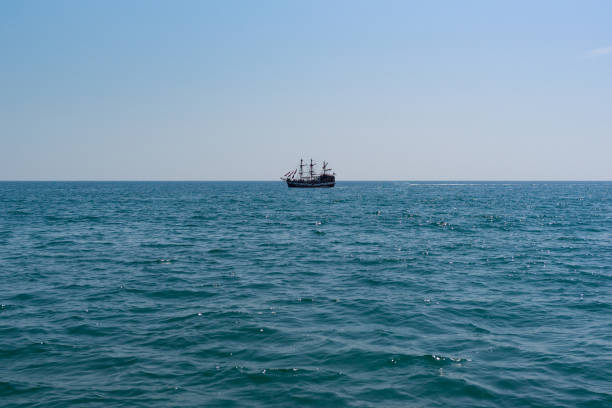 istock Sailing ship on calm on the horizon 877163226