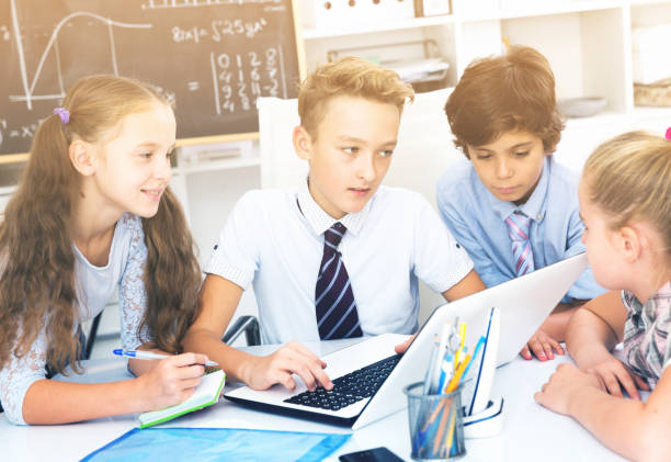 istock children near laptop talking about mathematics 877165156