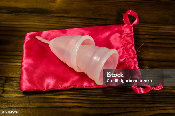 Two Menstrual Cups And Cotton Bag On A Wooden Table Stock Photo - Download Image Now