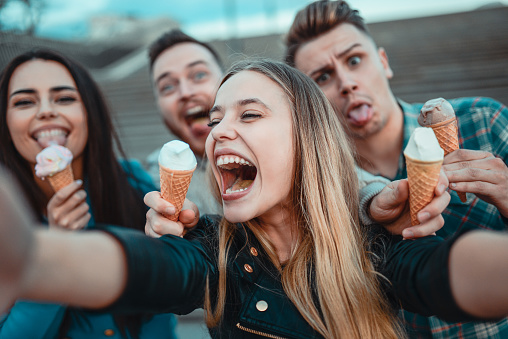 Smiling Friends Holding Cones with Ice Cream and Taking Selfie