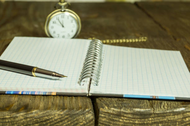 istock Open Blank Page notebook and pen on a rustic wooden desk. A textured background. Copy paste place 877183702