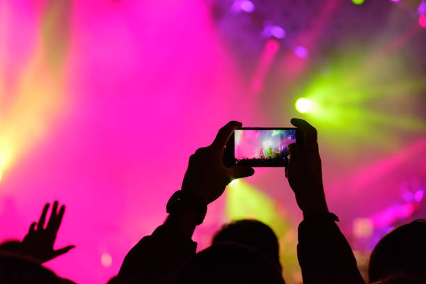 istock Concert visitor shoots video 877184524