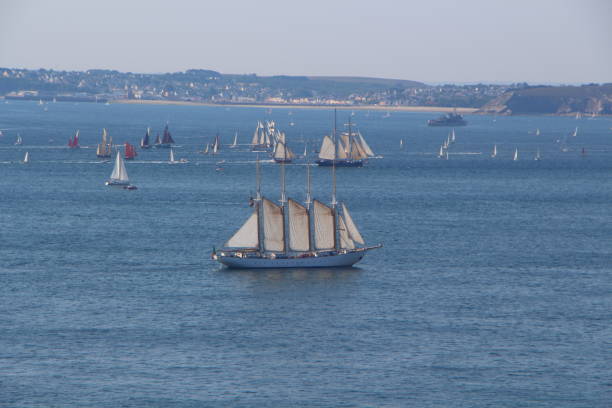 Amsterdam ,the netherlands - augustus 20 , 2015: Small recreation boats with people sailing along the great tall shipsduring the great nautical event SAIL 2015 