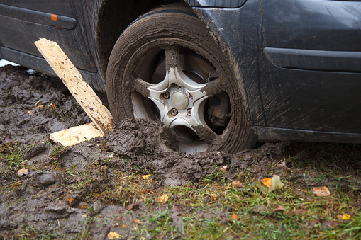 car wheel stuck in the wet mud