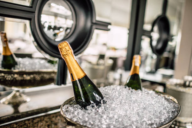 Champagne glass on bar, people in backgroud
