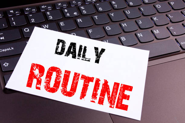 istock Writing Daily Routine text made in the office close-up on laptop computer keyboard. Business concept for Accuracy Procedure Workshop on the black background with copy space 877193458
