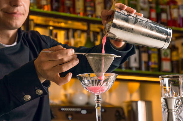 istock Charming bartender prepares a delicious cocktai 877195236