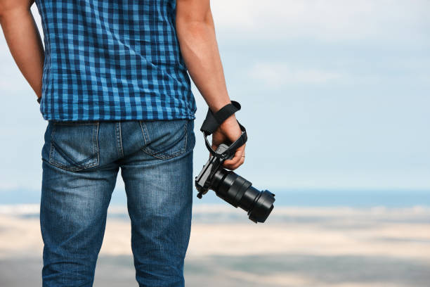 istock Photographer with camera in his hands 877198152