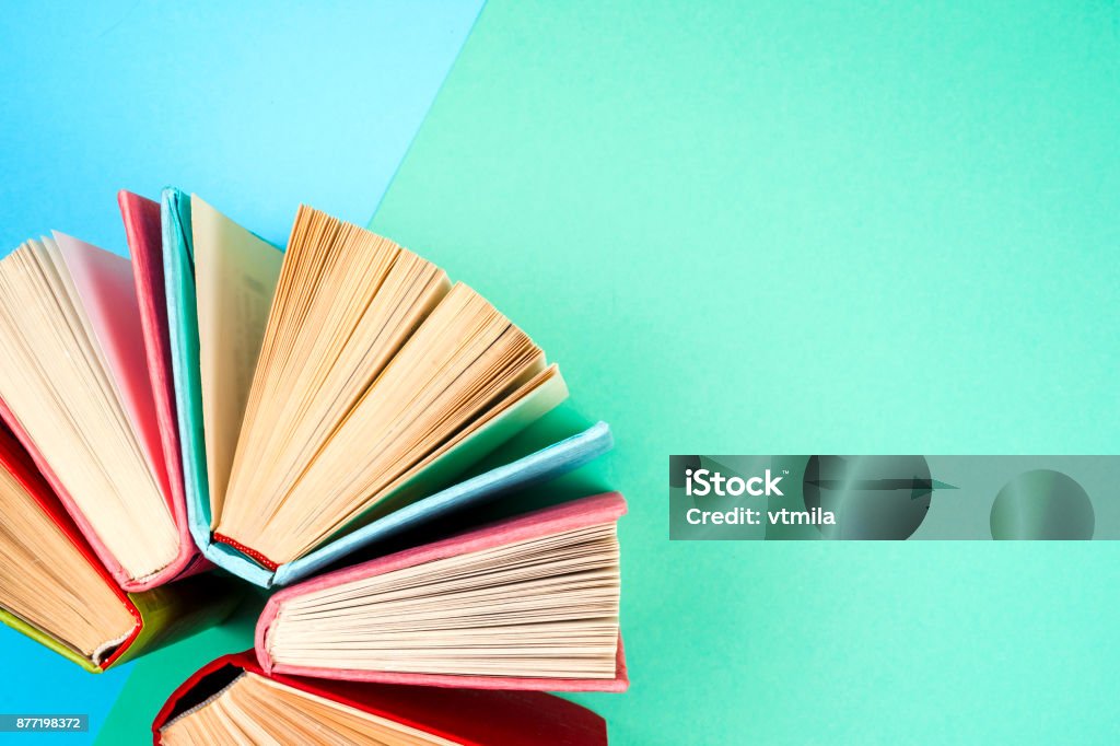 Top view of bright colorful hardback books in a circle. Top view of colorful hardback books in a circle. free copy space. Back to school copy space. Education background. Bookstore Stock Photo