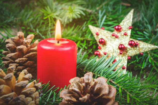 istock Christmas decor, red candle and pine cones 877202234