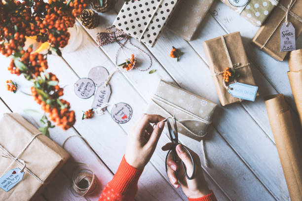 istock Woman hands wearing red sleeve sweater gift wrapping 877205996