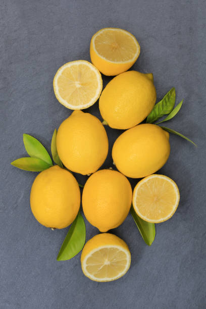istock Lemon lemons fruits portrait format slate top view 877208230