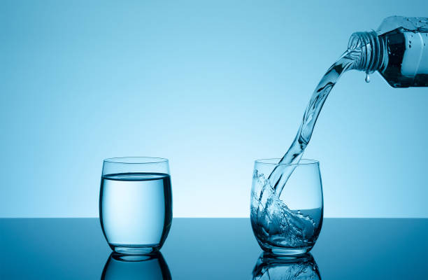 istock Creative splashing water in the glass 877208412