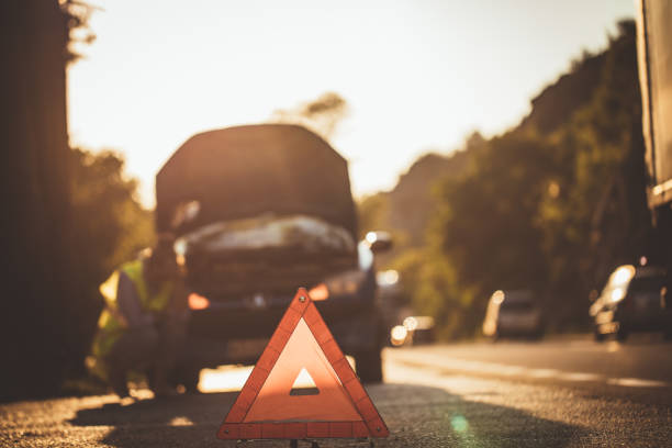 istock Woman with broken car 877208866