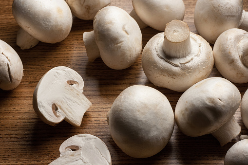 Fresh mushrooms Champignon on wooden table