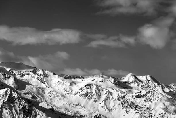 istock Black and white sunlight snow mountains at nice sun evening 877219848