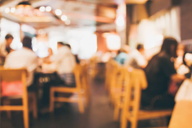 istock Restaurant cafe or coffee shop interior with people abstract blur background 877220334