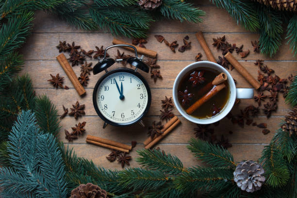 istock Cup of tea with star anise and cinnamon with alarm clock 877220436