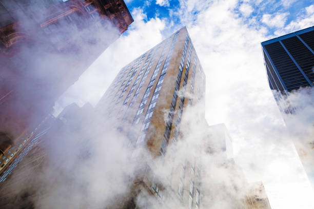 istock Manhattan apartment building tilted low angle view through steam 877223444