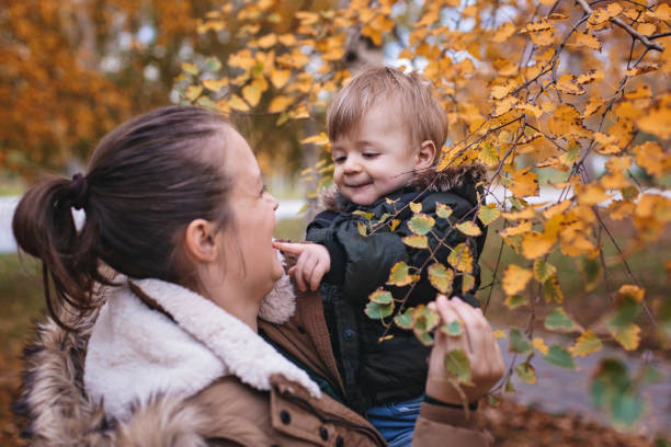 istock Mother playing with her cute little baby son 877223856