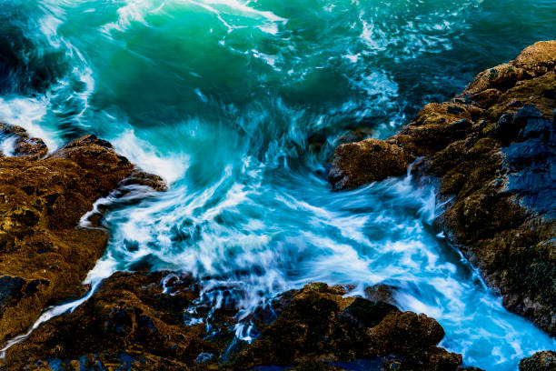 variations of images as the water is drawn back and waves come in to rocky section of Acadia National Park