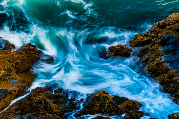 variations of images as the water is drawn back and waves come in to rocky section of Acadia National Park