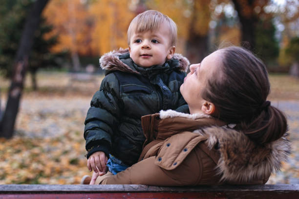 istock Beautiful young mother playing with her little son 877224348