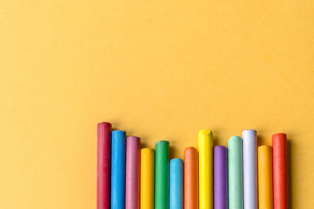 istock Colored wax crayons (oil pastel) on a yellow background. Top wiew.
Copy space. Colored background. 877227304