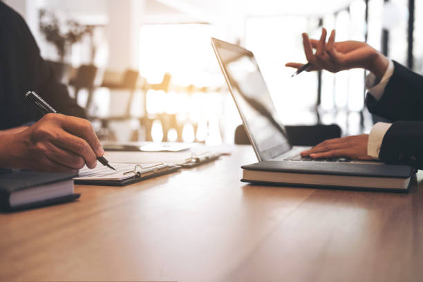 istock Two businessmen at work, Business crew working with new startup financial project plan,man and woman discussion information with laptop and digital tablet in a modern business lounge,Selective Focus 877228132