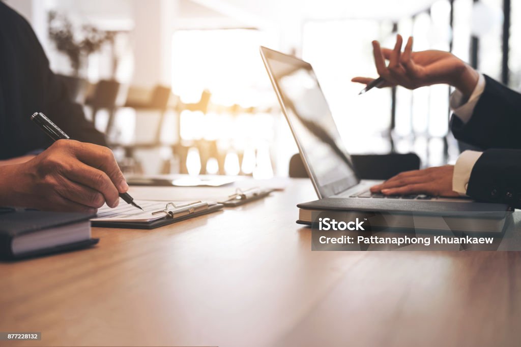 Two businessmen at work, Business crew working with new startup financial project plan,man and woman discussion information with laptop and digital tablet in a modern business lounge,Selective Focus Two businessmen at work, Business crew working with new startup financial project plan,man and woman discussion information with laptop and digital tablet in a modern business lounge,Selective Focus. Contract Stock Photo