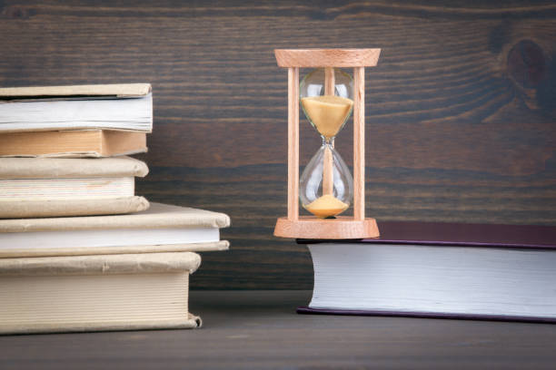 istock Sandglass, hourglass or egg timer on wooden table showing the last second or last minute or time out 877228502