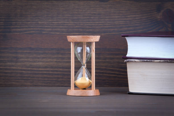 istock Sandglass, hourglass or egg timer on wooden table showing the last second or last minute or time out 877228506