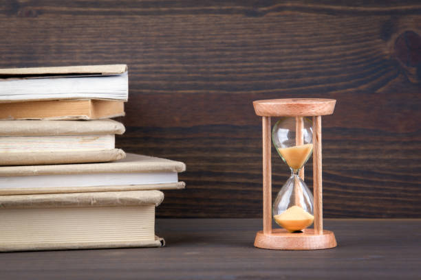 istock Sandglass, hourglass or egg timer on wooden table showing the last second or last minute or time out 877228518