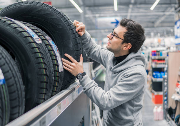 istock male customer choosing new tires 877232180