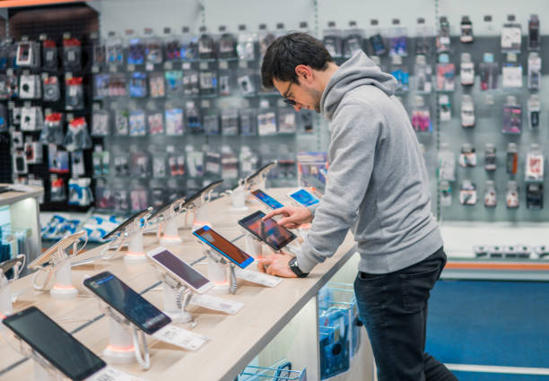 Smart male customer choosing digital tablet