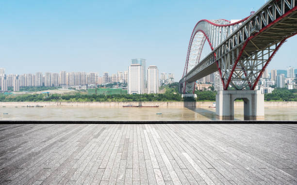 istock empty brick floor with modern bridge and cityscape 877238320