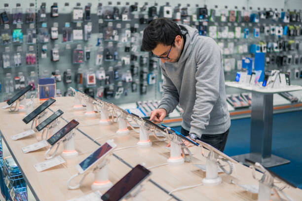 istock Smart male customer choosing smartphone 877238326