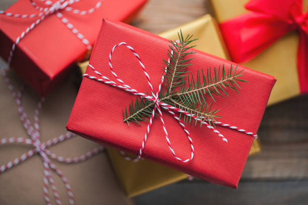 istock Christmas background with gift boxes on wooden background. Top view. Beautifully packaged multi-colored gifts for the new year or the day of the holy valentine 877238994