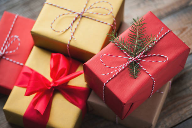 istock Christmas background with gift boxes on wooden background. Top view. Beautifully packaged multi-colored gifts for the new year or the day of the holy valentine 877239006