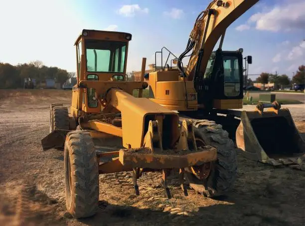 Photo of Construction and excavating equipment on gravel at a building site