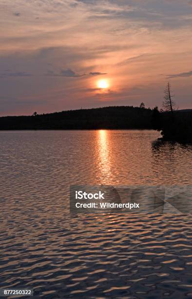 The Sun Setting Through Evening Clouds Stock Photo - Download Image Now - Beauty, Beauty In Nature, Boundary Waters Canoe Area