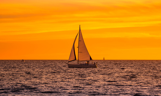 Sailboat in the ocean during sunset