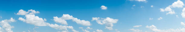 istock blue sky and White cloud nature: clear blue sky with plain white cloud with space for text background. 877260624