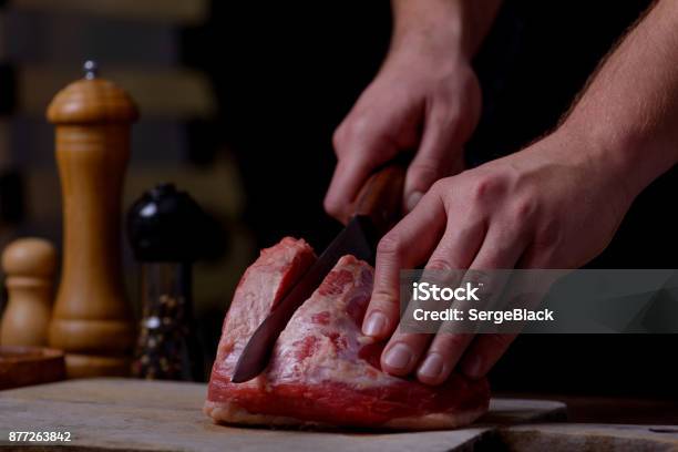 Man Cuts Beef Meat On Cutting Board Stock Photo - Download Image Now - Adult, Adults Only, Backgrounds