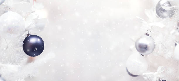 istock Black and silver bauble hanging from a decorated Christmas tree with background. 877266856